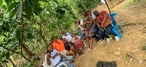 Group of women relaxing together under cacao trees in the Dominican Republic, natural and candid